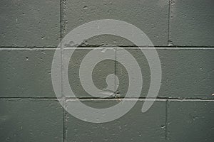 Cement block siding on a building grey and green