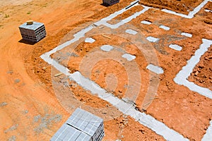 Cement blocks delivered to a construction site with foundation is ready for mounting wall