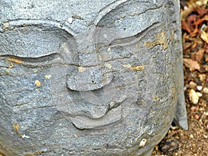 Cement Buddha Head in the Garden with some Lichen Beginning to Grow on It