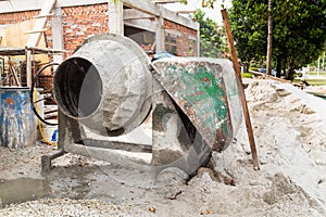 Cement concrete mixer with construction site in background