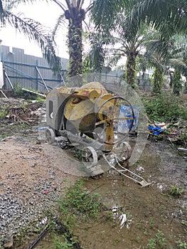 Cement or concrete mixer machine located on the construction farm