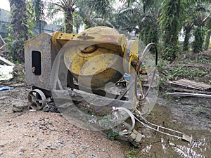 Cement or concrete mixer machine located on the construction farm