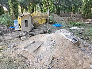 Cement or concrete mixer machine located on the construction farm