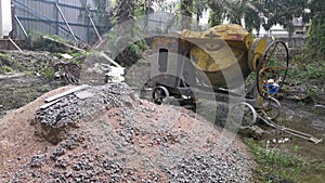 Cement or concrete mixer machine located on the construction farm