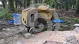 Cement or concrete mixer machine located on the construction farm