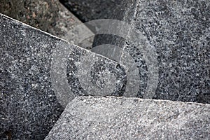 Cement cube outdoor in the sun producing a shadow. Grey background. Abstract construction. Cement bloks. Cubic design.