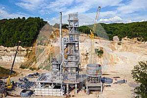 Cement factory at open pit mining of construction sand stone materials with excavators and dump trucks