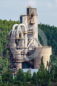 Cement factory, quarry with silos and industrial equipment. Limestone mining for cement production