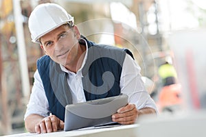 Cement manufacturing manager holding tablet