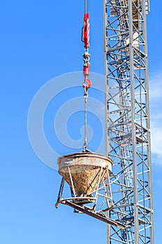 Cement Mixer Being Held Aloft by a Crane