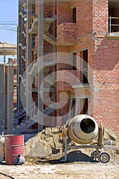 Cement mixer brick building and rubble on Spanish building site
