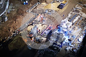 Cement mixer, crane and bulldozer at construction site