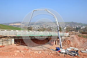 Cement mixer pouring concrete on a bridge