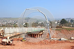 Cement mixer pouring concrete on a bridge