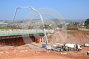 Cement mixer pouring concrete on a bridge