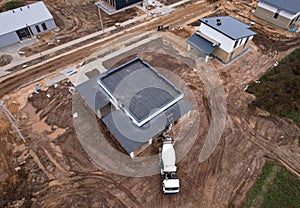 Cement mixer truck pouring mix during building a country house. Formworks and pouring concrete at private home of ceramsite