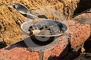 Cement Mortar Prepared in Metal Pan for Brickwork