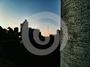 Cement pier with evening cityscape in the background