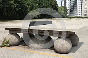 cement ping pong table outside outdoors in courtyard on cement spheres