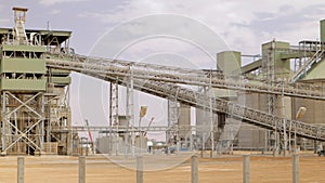 Cement plant with high factory structure and tower crane at industrial production area