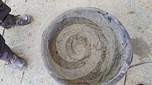 Cement in a plastic bucket. Large bucket with solution, top view.