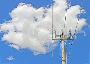 Cement power pole and three electricity lines in cloudy blue sky