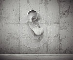 Cement sculpture in the shape of a human ear on a concrete wall