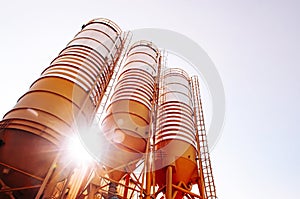 Cement silos of Cement batching plant against evening sun