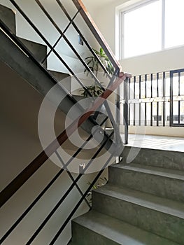 The cement stair up and down of building with square frame window