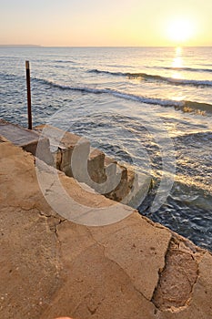 Cement stairs going down directly to the beach water from the homes