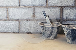 Cement tank and scoop into brick blocks in construction area