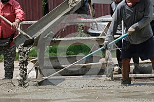 cement truck pour fluid concrete into floor house . Group of worker working mixer material in site