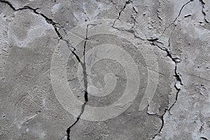 Cement wall cracks. Cement is gray. Texture.