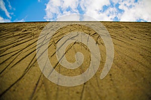 Cement wall scratches blue sky clouds