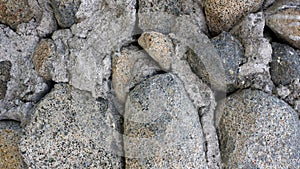 cemented mountain rocks and used as house fences photo