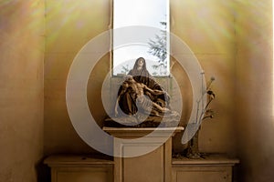 Cementery vintage sculpture of madonna, tombestone, sadness concept, catholic comunity