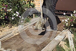 Cementing garden paths on top of metal mesh, construction work in the garden