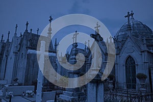 Cemetery crosses and vaults by night