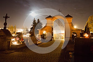 Cemetery at night. Burning candles on the graves. photo