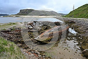 Cemetery of old ships on the coast of the Barents Sea in Teriberka, Russia