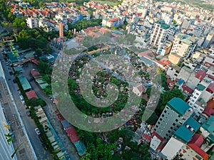 Cemetery surrounding by dense of multistory residential houses caged balcony, row of high-rise apartment tower complex background