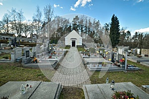 Cemetery with tombstones in the shape of a cross, angels. Many decorated graves