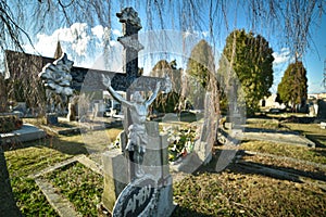 Cemetery with tombstones in the shape of a cross, angels. Many decorated graves