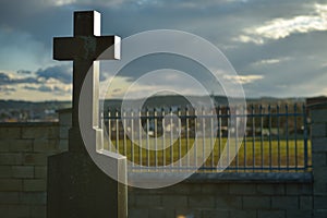 Cemetery with tombstones in the shape of a cross, angels. Many decorated graves