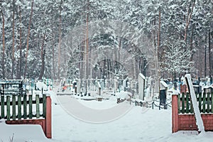 cemetery on a winter day, graves under the snow