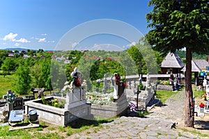 Cemetery in the yard of The Wooden Church from Plopis village, Maramures county, Romania.