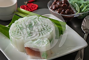 Cendol Red Bean Jelly Mooncake, served on white plate, with pandan leaves