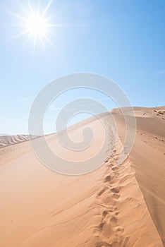 Cenic ridges of sand dunes with footprints in Sossusvlei, Namib Naukluft National Park, best tourist and travel attraction in