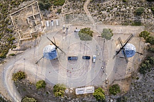 Cenital aerial view of a pair of ancient windmills on top of a hill in Alcublas, Spain photo