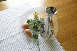 Cenital shot of eggs, parsley, pepper shaker, and olive photo